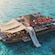 A floating ocean club featuring lounge chairs and a slide in Cozumel, Mexico